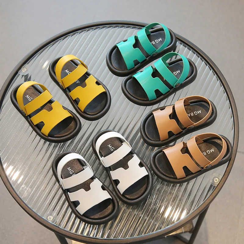 Colorful kids' sandals in yellow, green, brown, and white.