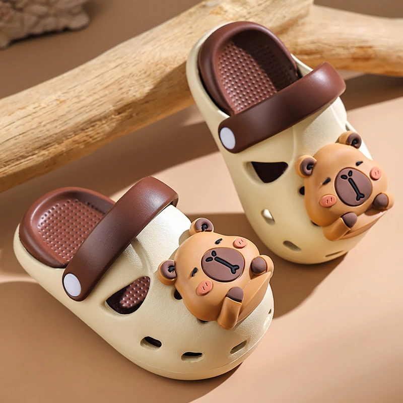 Cute beige and brown baby sandals with 3D teddy bear design.