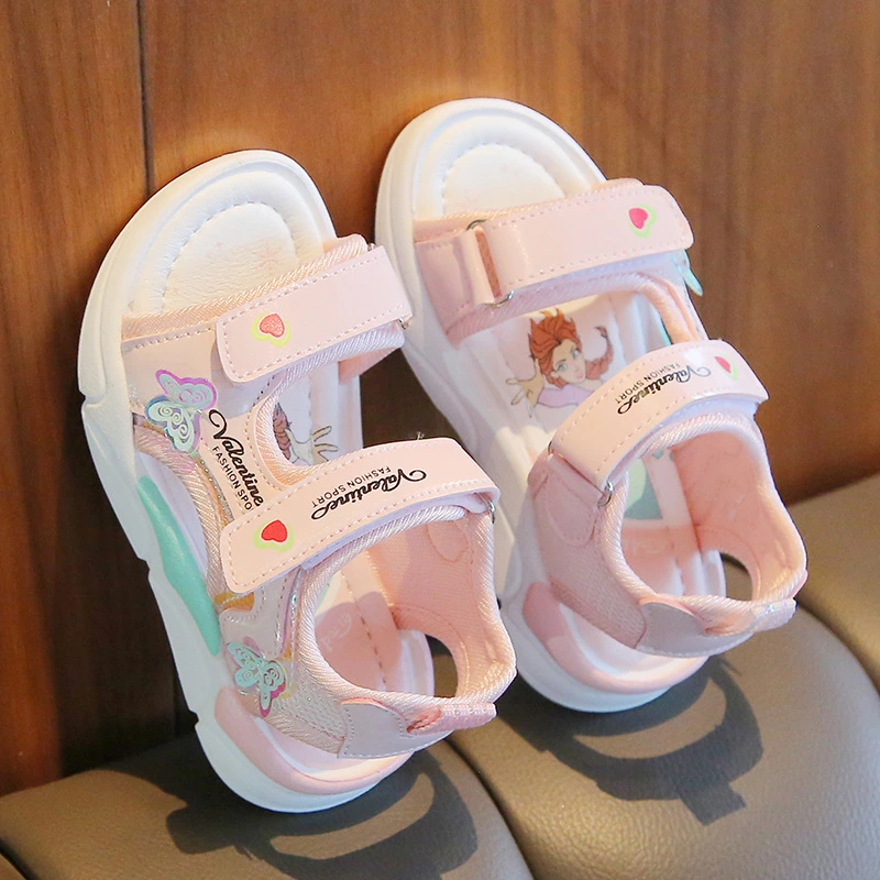 Pink toddler sandals with cute cartoon design and Velcro straps.