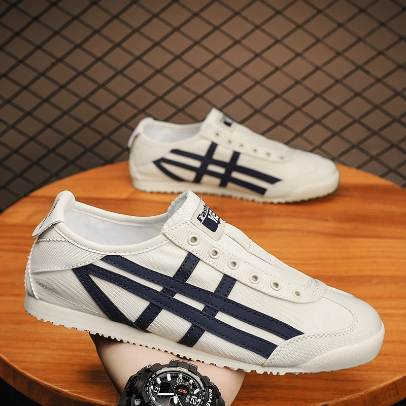 Yellow retro-style casual sneakers with black stripes on a grey carpet background.