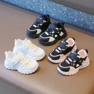 Trendy kids sneakers in black, white, and pink colors with velcro straps and chunky soles for comfort and style.