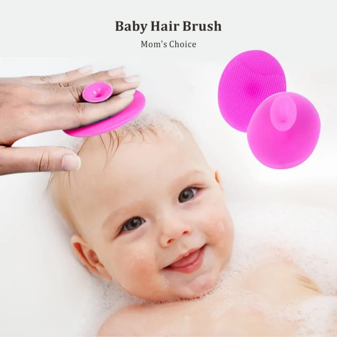 Soft pink silicone baby hair brush with finger grip for gentle scalp massage, cradle cap removal, and newborn hair care.